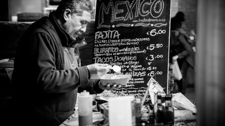 Mexican street food stall with handwritten Spanish menu signs, illustrating Mexican Spanish to English vocabulary
