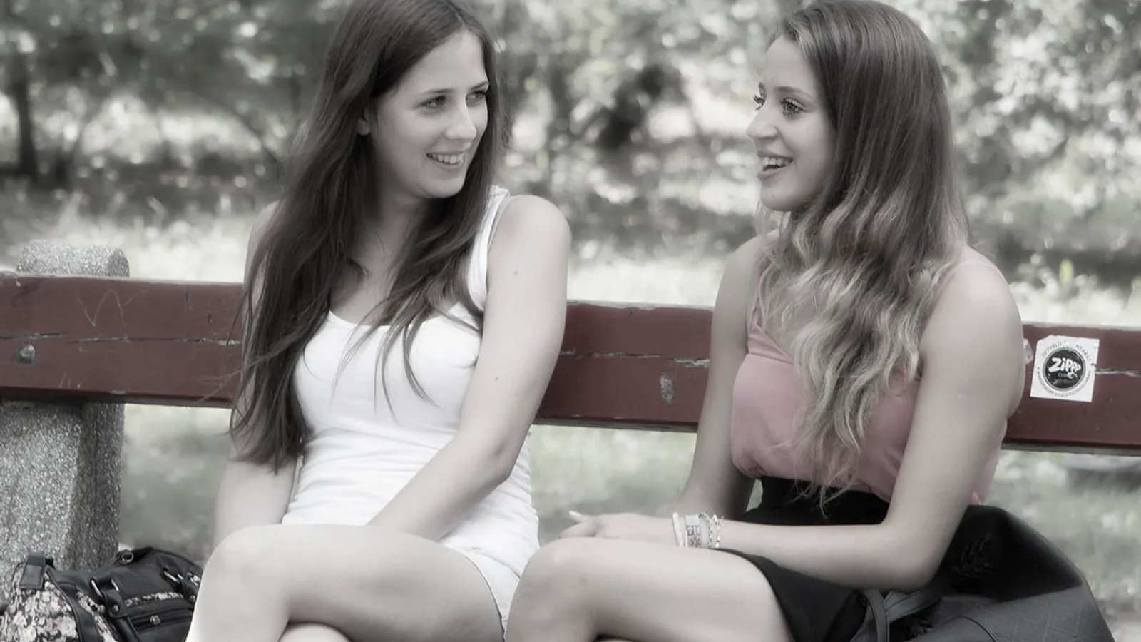Young friends chatting outdoors in a Spanish city street, the casual talk where Spanish slang words are used